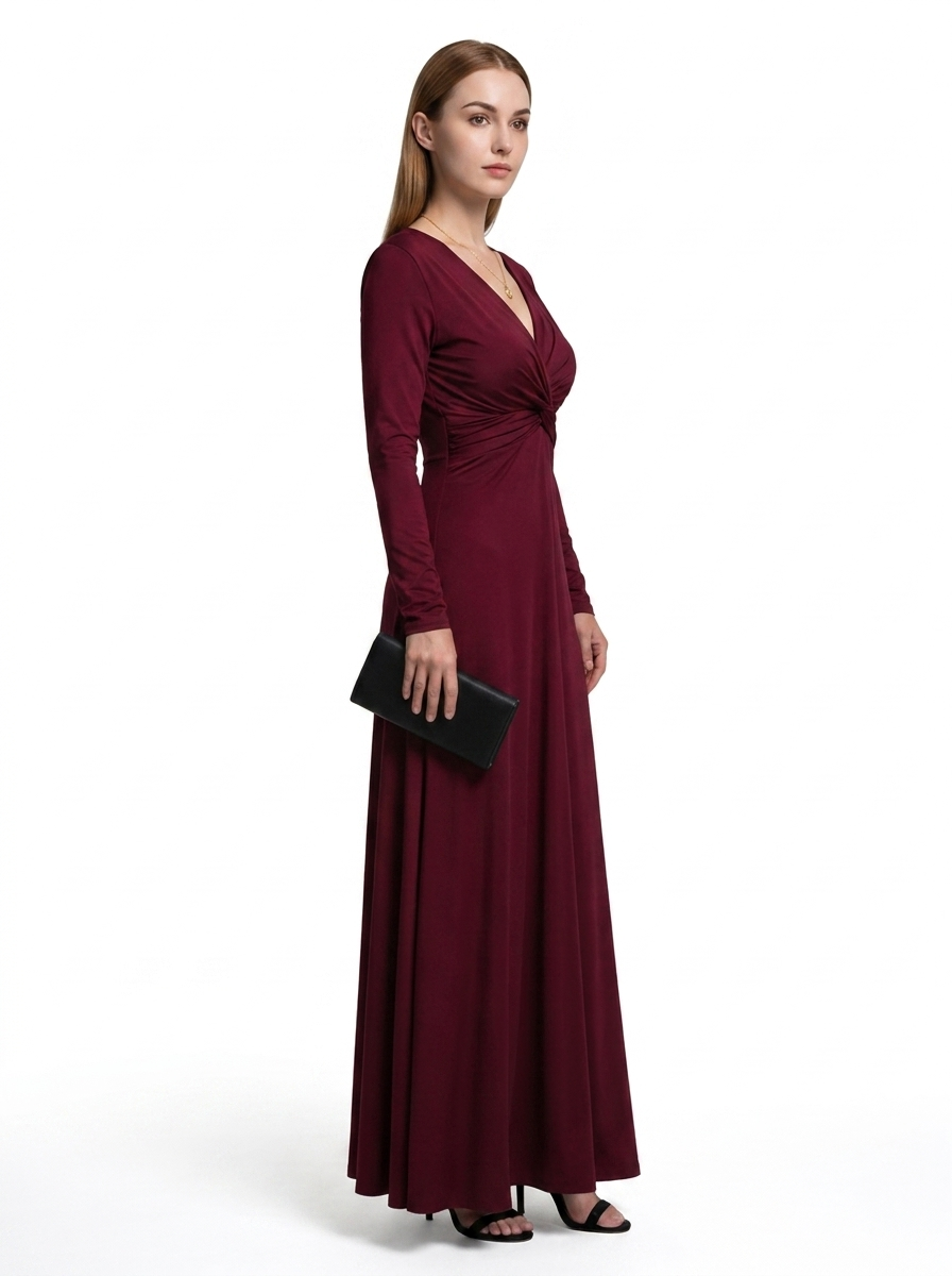 Woman wearing a burgundy evening gown with a black clutch on a white background