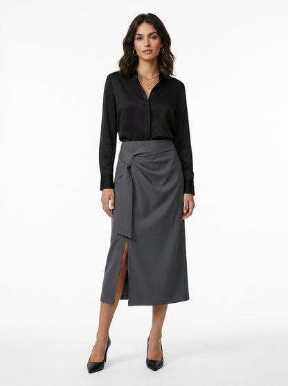 Woman wearing a black shirt and gray skirt on a white background