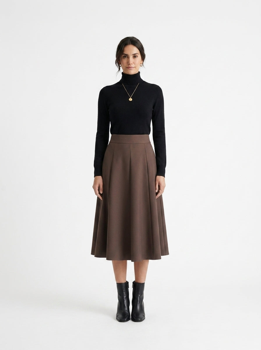 Woman wearing a black turtleneck and brown skirt on a white background