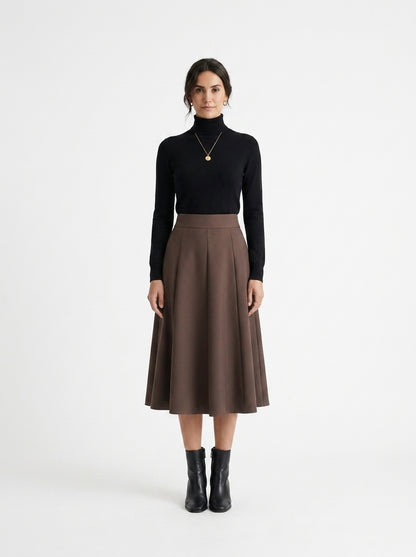 Woman wearing a black turtleneck and brown skirt on a white background
