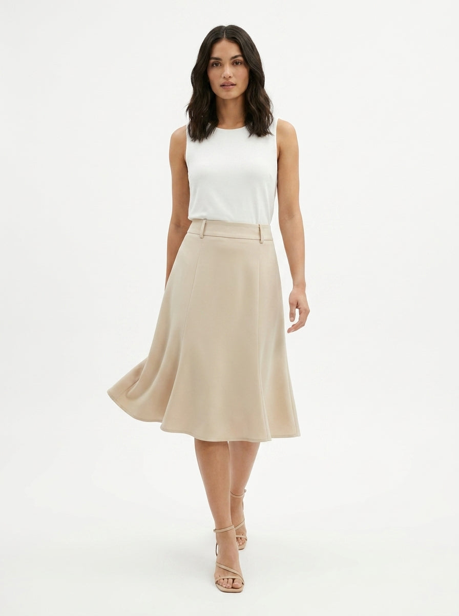 Woman wearing a white top and beige skirt on a white background