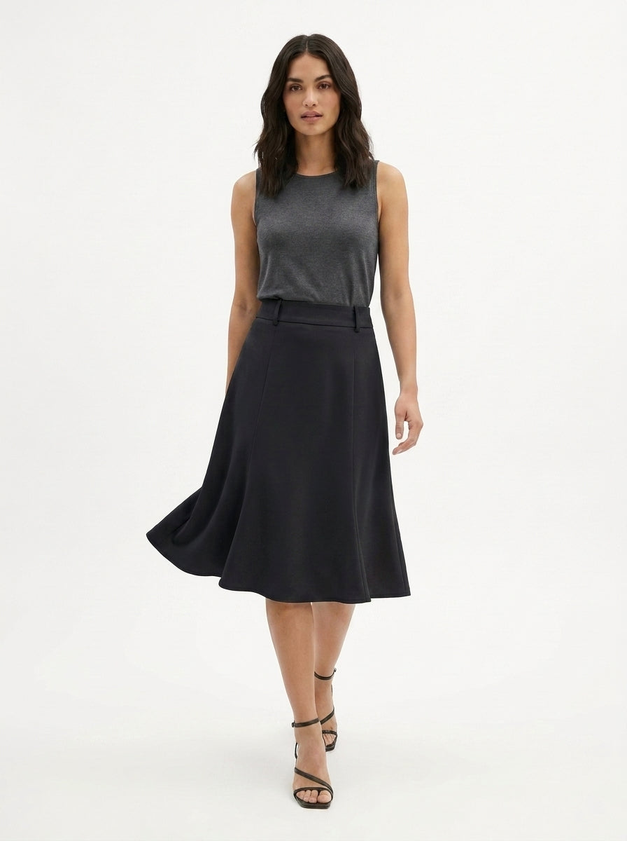 Woman wearing a gray sleeveless top and black skirt on a white background