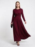Woman wearing a burgundy long-sleeve dress on a white background