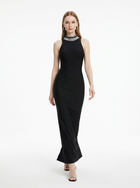 Woman wearing a black sleeveless dress on a white background