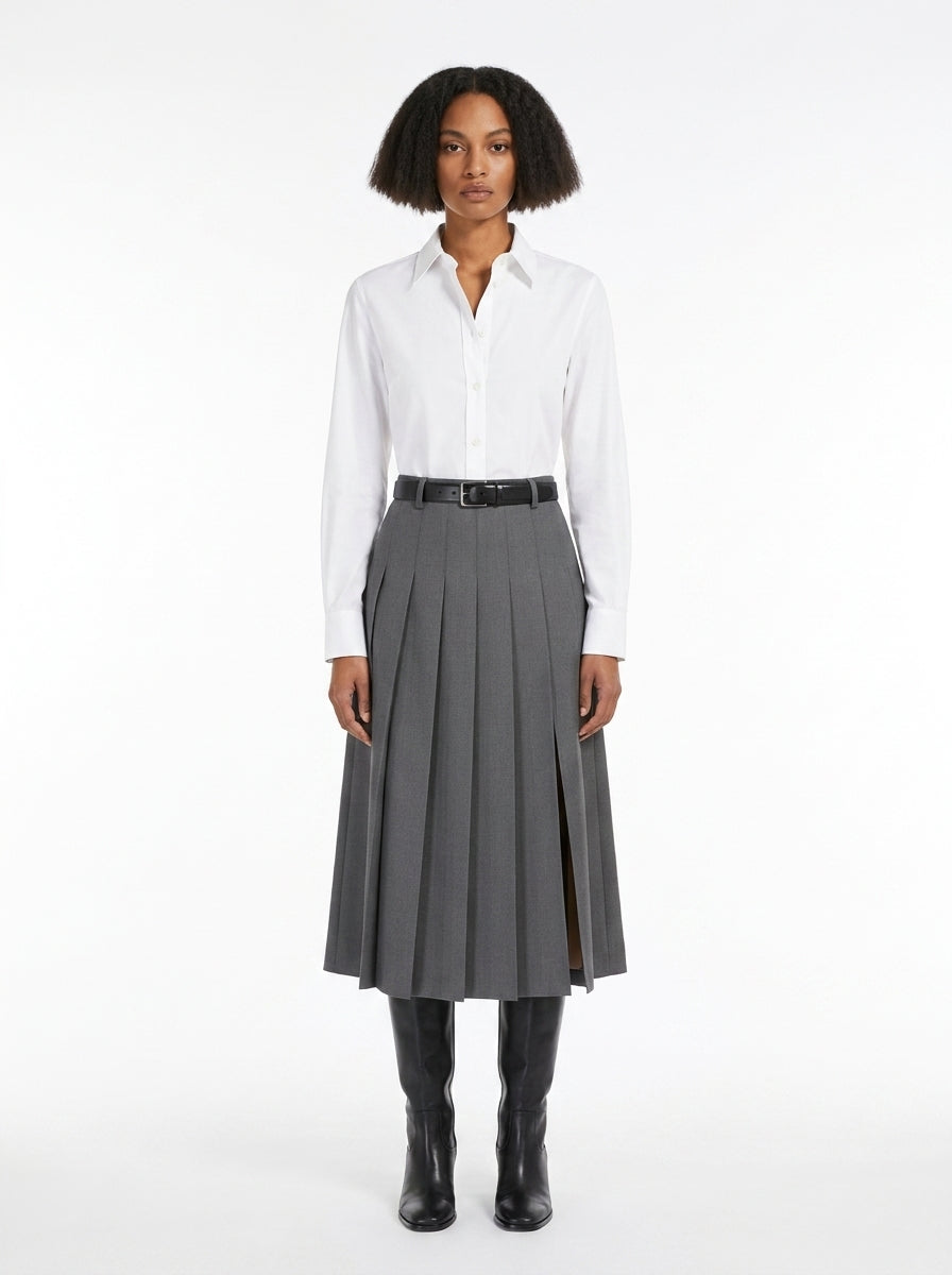 Woman wearing a white shirt and gray pleated skirt on a white background