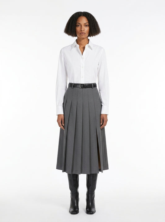 Woman wearing a white shirt and gray pleated skirt on a white background