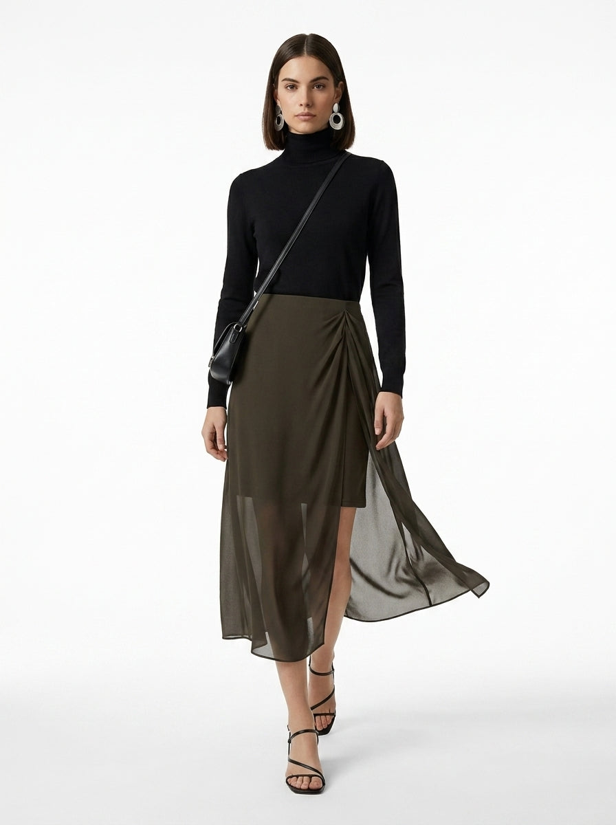 Woman wearing a black turtleneck and dark green skirt on a white background